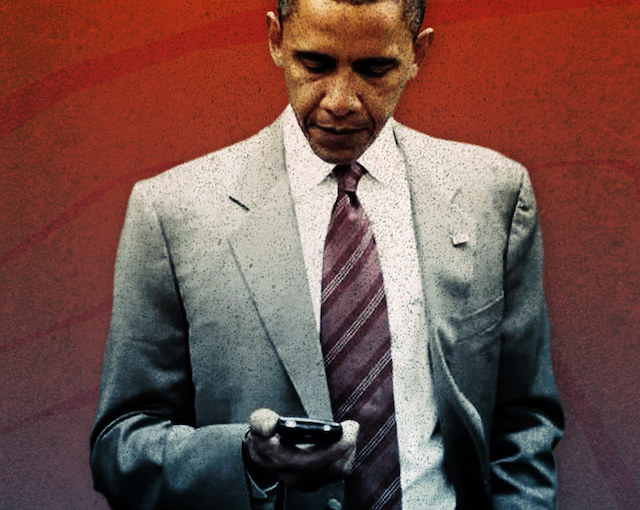 President Obama looking at a BlackBerry in his hand